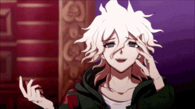 a boy with white hair is smiling and making a funny face