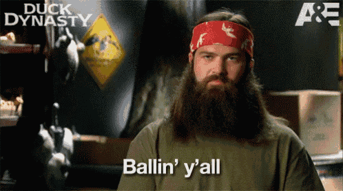a man with a beard says ballin ' y 'all in front of a sign that says duck dynasty