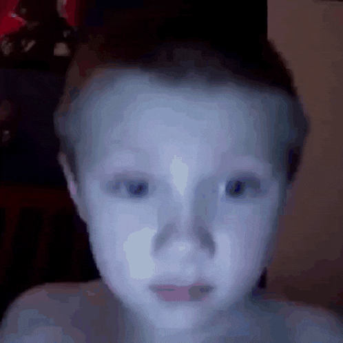 a close up of a child 's face with a blurred background .