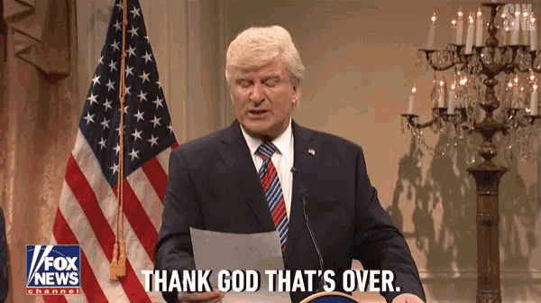a man in a suit and tie is giving a speech and says thank god that 's over ..