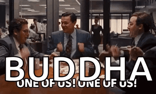 three men are sitting at a table with the words buddha one of us