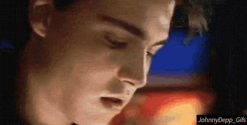 a close up of a man 's face with the words johnny depp gifs below him