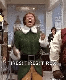 a man in a green elf costume is shouting in a store .