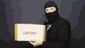 a man wearing a black mask is holding a box