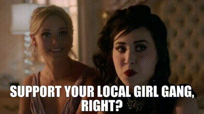 two women are sitting next to each other with the words support your local girl gang , right ?