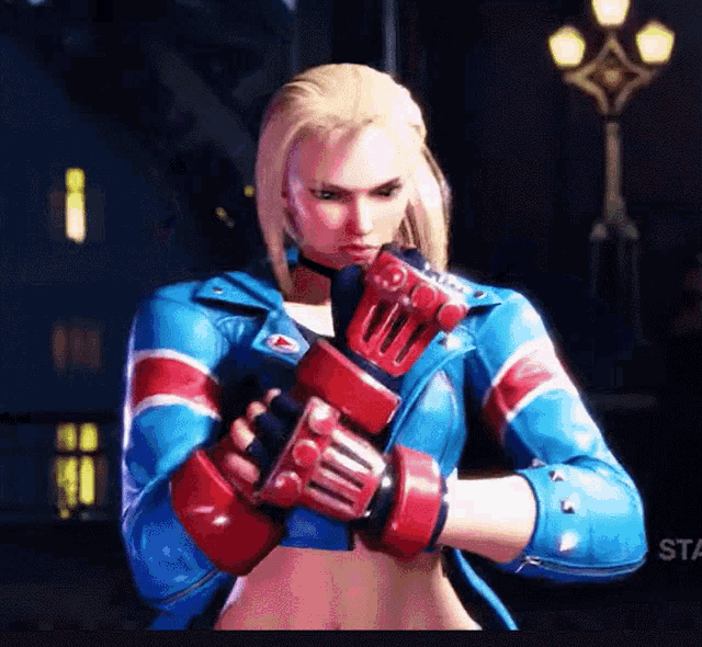 a woman wearing boxing gloves is standing in front of a sign that says sta