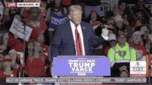 donald trump is giving a speech in front of a crowd of people