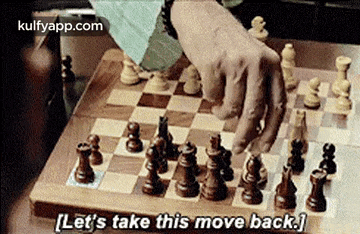 a person is playing a game of chess on a wooden board and says `` let 's take this move back '' .