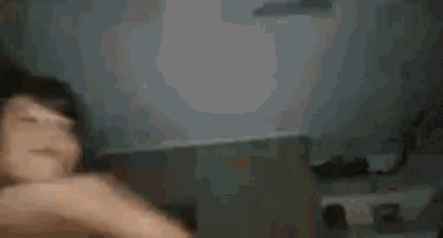 a blurry picture of a person 's face with the words tenissinet written on the bottom .