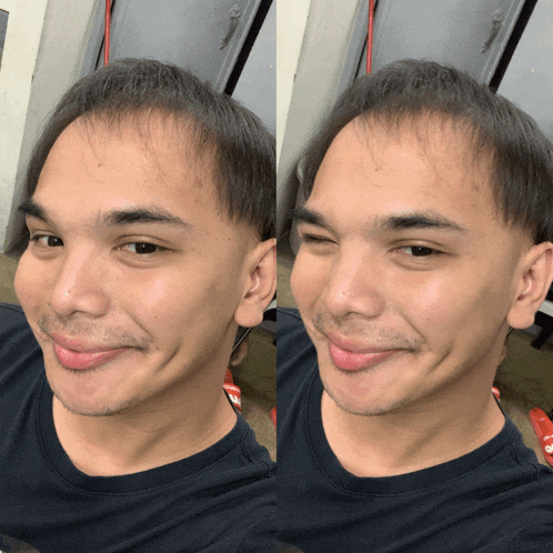 a man in a black shirt is smiling and making a silly face