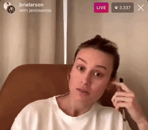 a woman is sitting in a chair with a live button above her head