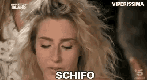 a close up of a woman 's face with her eyes closed and the word schifo written on her face .