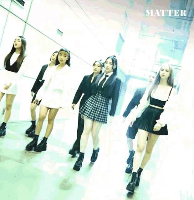 a group of girls are dancing in a hallway with the words the matter in the corner