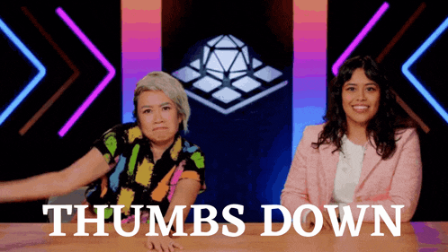 two women sitting at a table with the words thumbs down written on the bottom