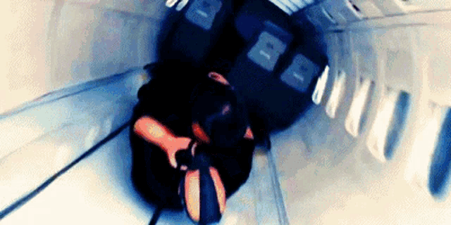 a person is sitting on a staircase with the letter b on the wall behind them
