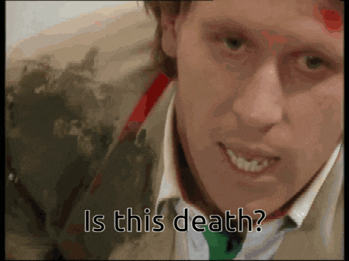 a close up of a man 's face with the words " is this death " above him