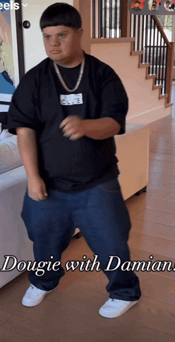 a man in a black shirt and blue jeans is dancing with the words dougie with damian above him