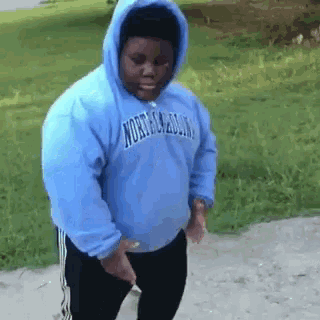 a man wearing a blue hoodie that says north dakota