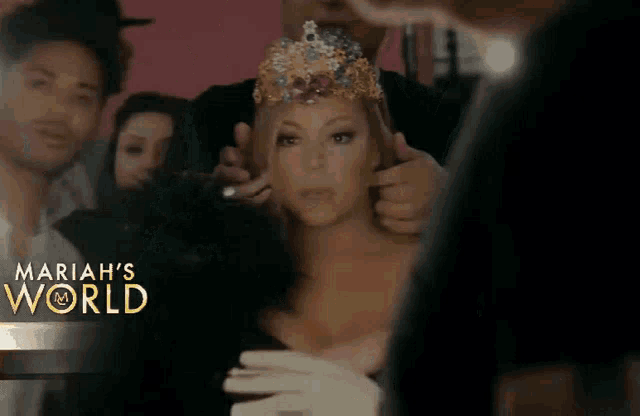 a woman wearing a crown is surrounded by people with the words mariah 's world on the bottom right