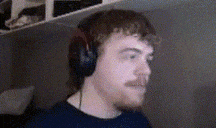 a man with a mustache wearing headphones and a black shirt