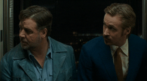 two men standing next to each other in a doorway