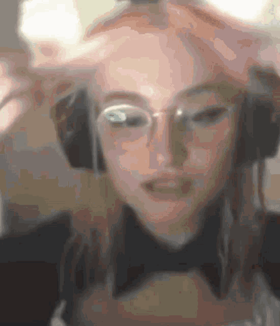 a close up of a woman wearing headphones and a bow tie .