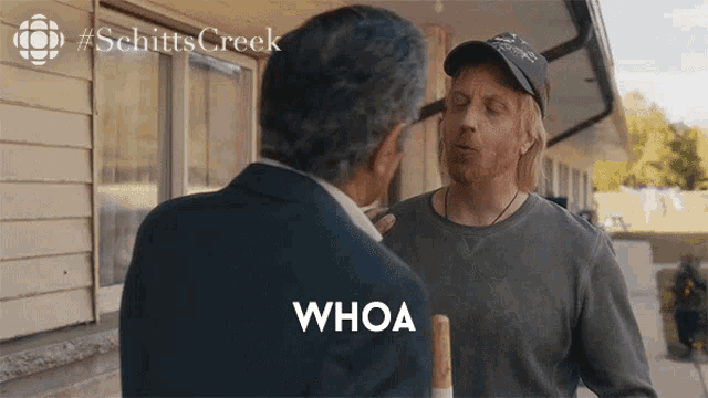 a man talking to another man with the word whoa in front of them
