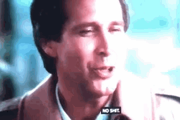 a close up of a man 's face with the words `` no shit '' visible .