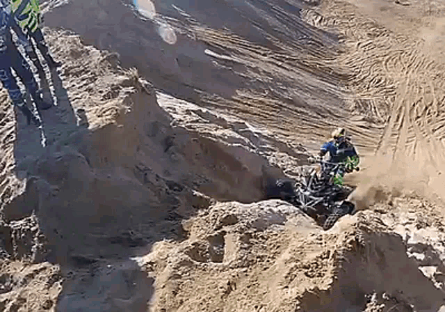 a person is riding a dirt bike on a dirt track .