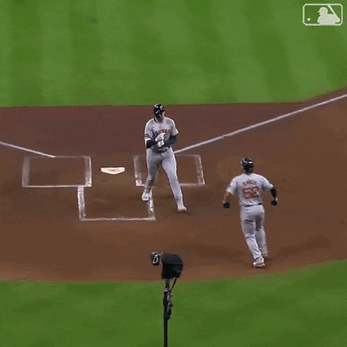 a baseball player with the number 52 on his jersey is running towards the base