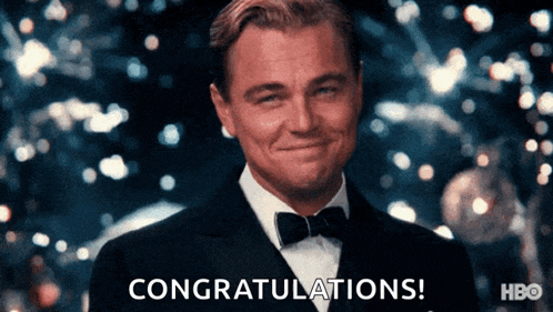 a man in a tuxedo is smiling with the words congratulations behind him