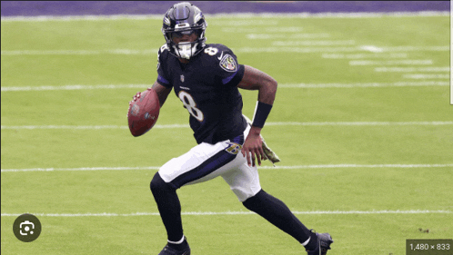 a football player with the number 8 on his jersey is running with a ball