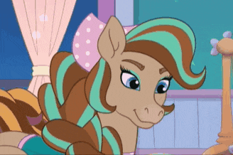 a cartoon pony with a bow on her head is laying on a bed