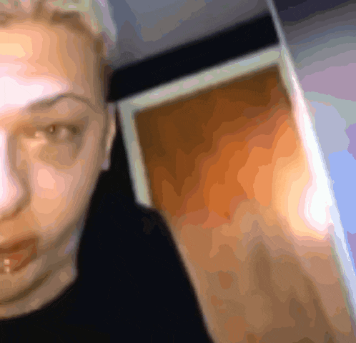 a blurry picture of a person 's face with a door behind them