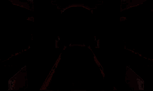 a girl in a pink dress is standing in a dark room with a heart in the background .