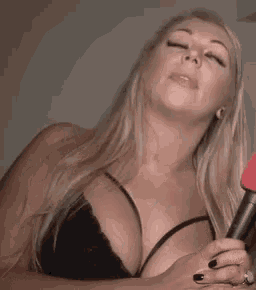 a woman in a black bra is laughing and looking up
