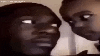 two people are looking at each other with their eyes closed and making funny faces .