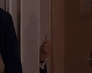 a man in a suit and tie with a pin that says ' x ' on it