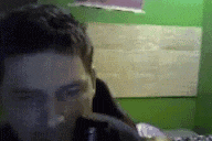 a blurry picture of a man 's face in a room with a green wall