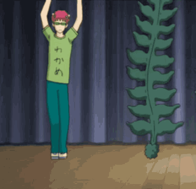 a person wearing a green shirt with chinese writing on it stands on a stage