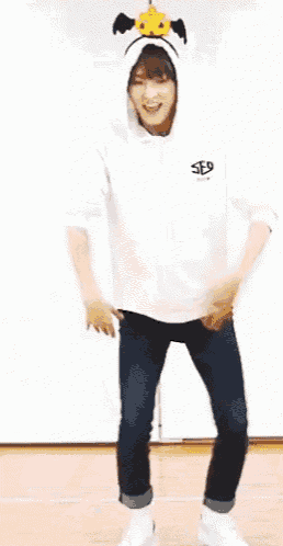 a person wearing a cow hat is jumping in the air with their legs crossed .