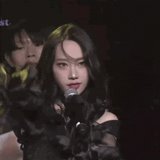 a man and a woman are standing next to each other on a stage .