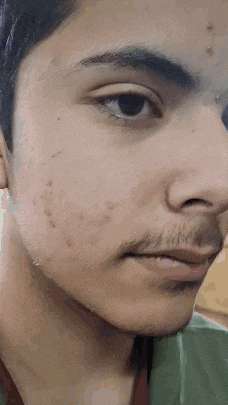 a close up of a man 's face with a beard