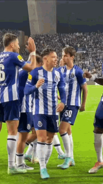 a group of soccer players are standing on a field .