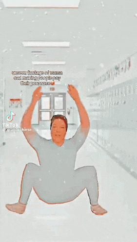 a man is sitting on the floor with his fist in the air and says do you see mama oiws new video yet ??