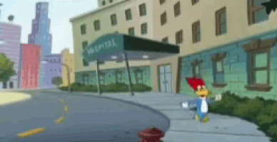 woody woodpecker is walking down the sidewalk in front of the hospital
