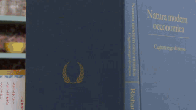 a blue book titled natana modern economica sits on a shelf next to a robot