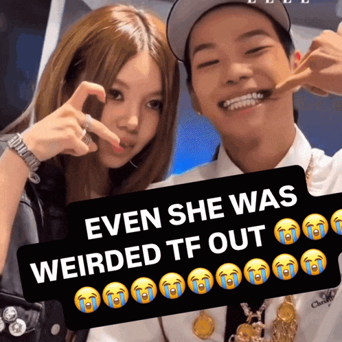 a man and a woman are posing for a picture with a sign that says even she was weirded tf out