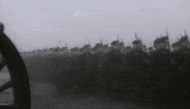 a black and white photo of soldiers marching with guns