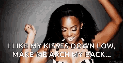 a woman is dancing with her arms in the air and says `` i like my kisses down low make me arch my back ... ''